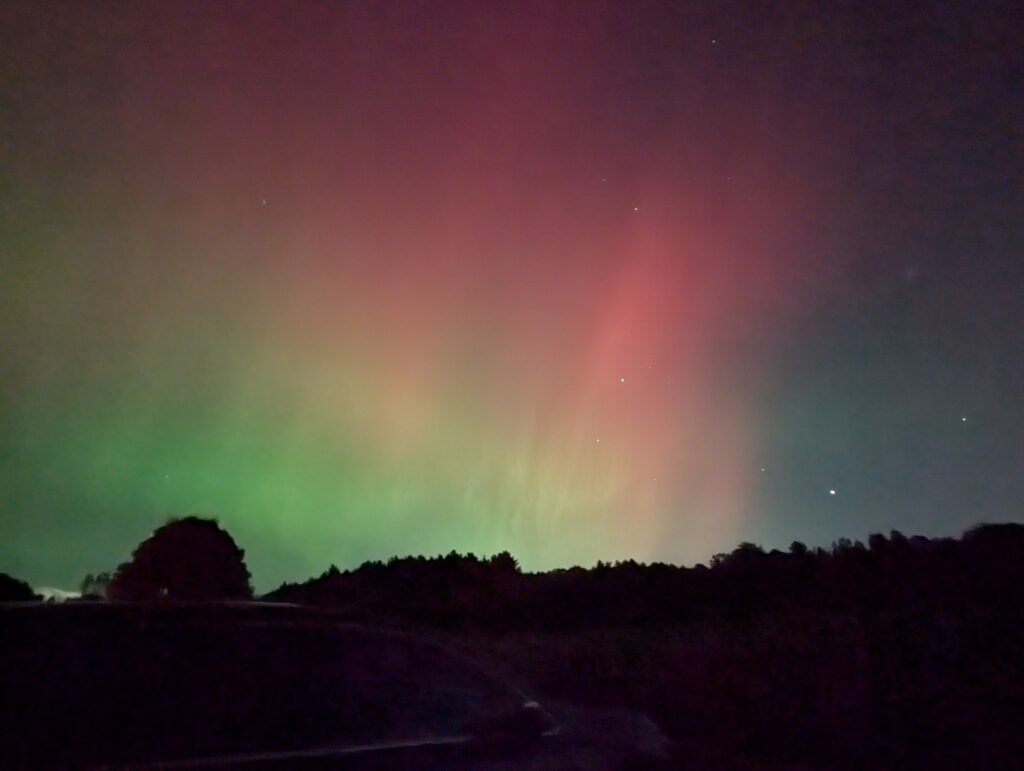 The night sky with impressive streaks of pink and greeen.