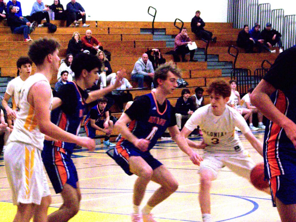 A bunch of boys head towards the AB player who is running with the ball.