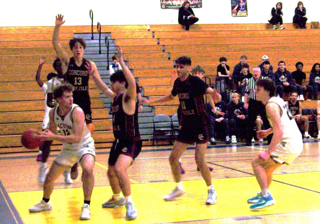 AB in white, CC in black. An AB player holding the ball tries to slide out from behind a CC player.